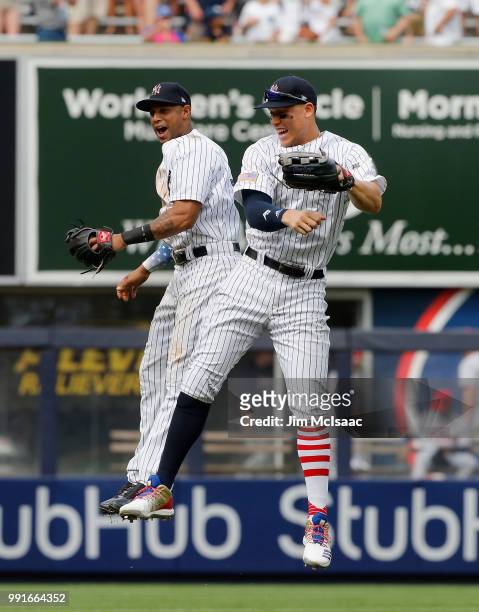 Aaron Judge and Aaron Hicks of the New York Yankees celebrate after defeating the Atlanta Braves at Yankee Stadium on July 4, 2018 in the Bronx...