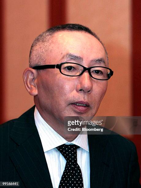 Tadashi Yanai, chairman, president and chief executive officer of Fast Retailing Co., walks inside a conference room in Shanghai, China, on Thursday,...