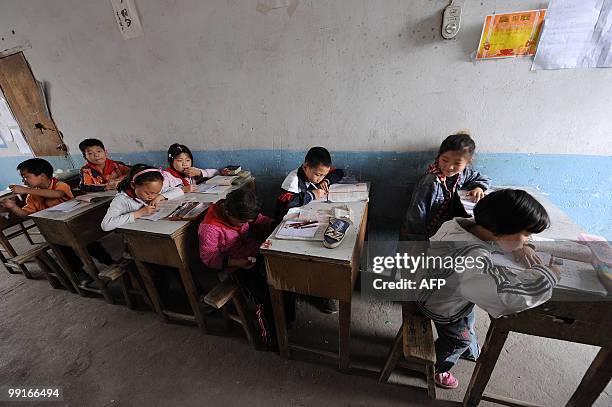 Chinese schoolchildren attend a class at a rural elementary school in Hefei, central China's Anhui province on May 12, 2010. The latest deadly school...