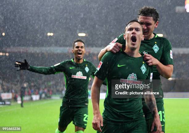 Bremen's Max Kruse celebrates his 3-0 goal with team mates Theodor Gebre Selassie and Milos Veljkovic during the German Bundesliga soccer match...