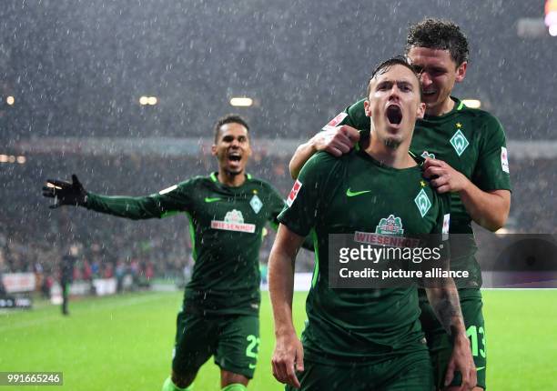 Bremen's Max Kruse celebrates his 3-0 goal with team mates Theodor Gebre Selassie and Milos Veljkovic during the German Bundesliga soccer match...