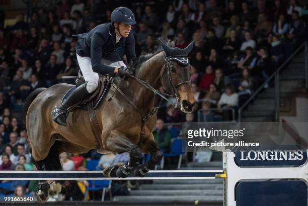 The show jumper Henrik von Eckermann from Sweden jumps over an obstacle with his horse Newton Abbot during the the FEI World Cup championship at the...