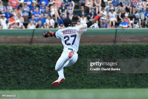 Addison Russell of the Chicago Cubs makes a catch on JaCoby Jones of the Detroit Tigers during the sixth inning on July 4, 2018 at Wrigley Field in...