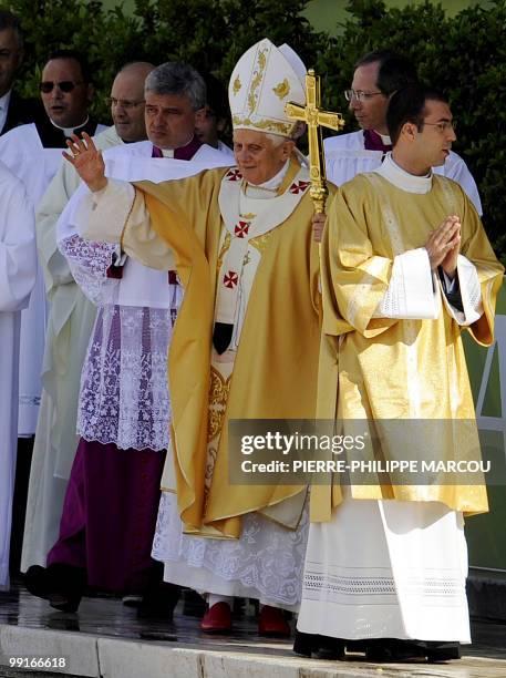 Pope Benedict XVI waves to the crowd upon arrival to lead an open-air mass at Fatima's Sanctuary on May 13, 2010. Half a million pilgrims are...