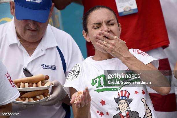 Michelle Lesco competes in the women's annual Nathan's Hot Dog Eating Contest on July 4, 2018 in the Coney Island neighborhood of the Brooklyn...