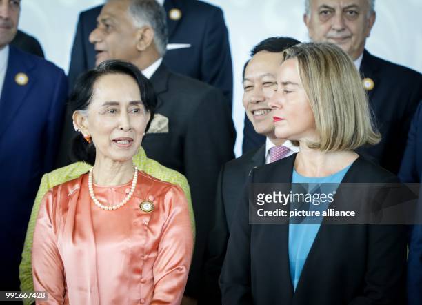 Factual head of state and Foreign Minister Aung San Suu Kyi stands next to EU High Representative Federica Mogherini during the 13th Asia-Europe...