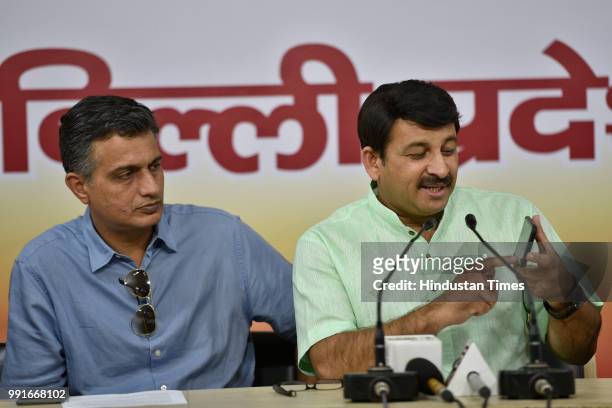Manoj Tiwari, Delhi BJP President, along with party member Neelkanth Bakshi holds a press conference about the government hiking the minimum support...