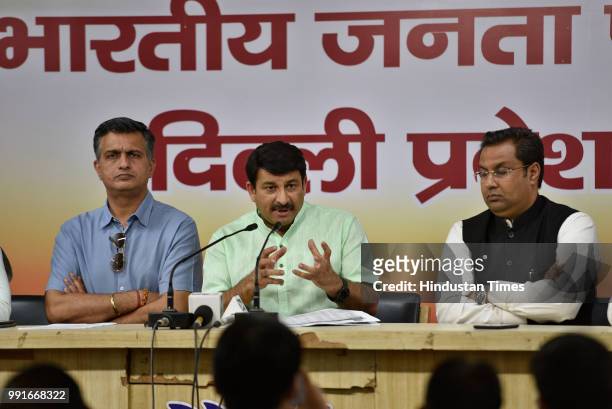 Manoj Tiwari, Delhi BJP President, along party members Neelkanth Bakshi and Aman Sinha holds a press conference about the government hiking the...