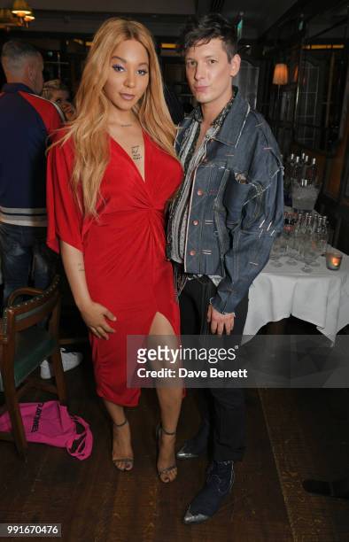 Munroe Bergdorf and Damon Baker attend the Gay Times dinner hosted by Kyle De'Volle at The Ivy Market Grill on July 4, 2018 in London, United Kingdom.