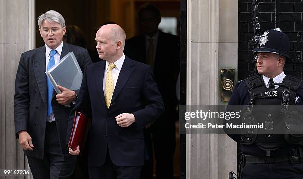 New members of the Cabinet, International Development Secretary Andrew Mitchell and Foreign Secretary William Hague leave Number 10 Downing Street...