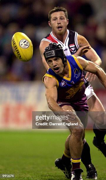 Shaun Hart of Brisbane in action against Craig Callaghan of St Kilda during the round 14 AFL match between the Brisbane Lions and St Kilda Saints at...