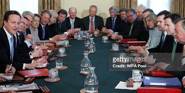 Prime Minister David Cameron , of the new coalition government, chairs his first cabinet meeting, opposite Deputy Prime Minister Nick Clegg, at 10...