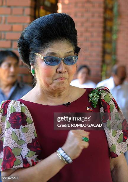 Philippine former first lady Imelda Marcos gestures while meeting supporters in Laoag city, northern province of Ilocos Norte, on May 13 following...