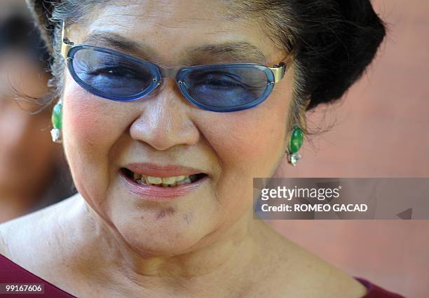 Philippine former first lady Imelda Marcos smiles while meeting supporters in Laoag city, northern province of Ilocos Norte, on May 13 following her...