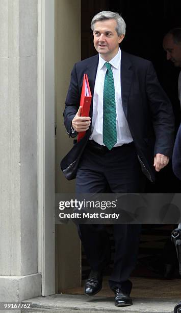 Energy and Climate Change Secretary Chris Huhne leaves Downing Street following the first cabinet meeting of the new coalition government at Downing...