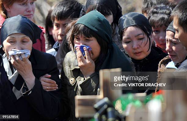 Friends and relatives cry during a funeral for a miner killed in the Raspadskaya coal mine blast, in Mezhdurechensk on May 13, 2010. The death toll...
