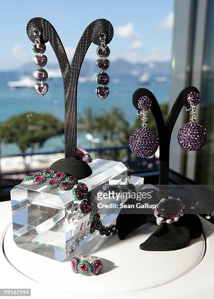 Earrings, bracelets and brooches covered with hundreds of diamonds and other precious stones lie on display at the de Grisogono showroom at the...