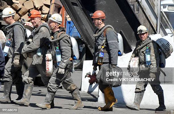 Russian miners walk from the Raspadskaya coal mine, in Mezhdurechensk on May 13, 2010 after making a rescue attempt. The death toll following twin...