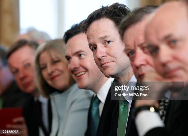 Deputy Prime Minister Nick Clegg looks on as Prime Minister David Cameron chairs his first cabinet meeting, at 10 Downing Street, on May 13, 2010 in...