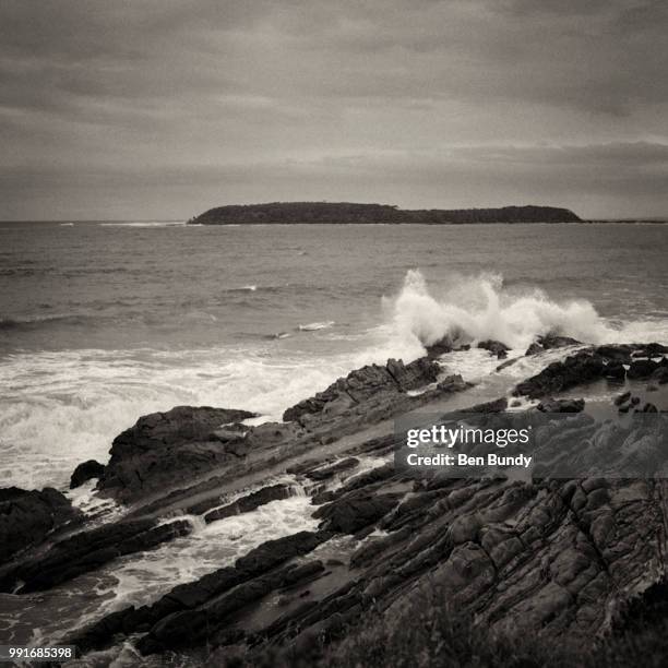 broulee island from mossy point headland - bundy stock pictures, royalty-free photos & images