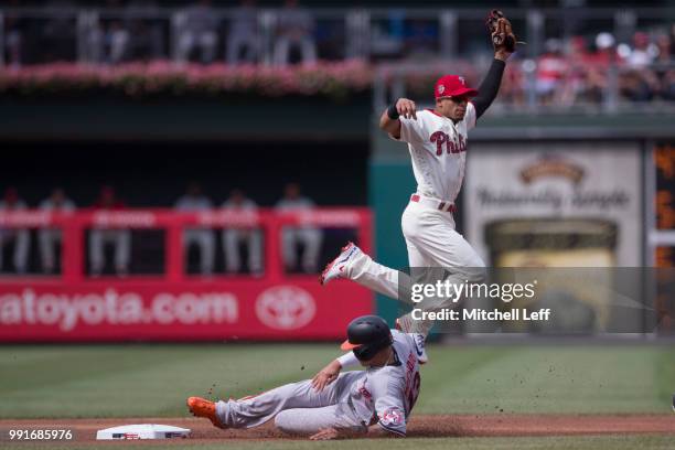 Manny Machado of the Baltimore Orioles steals second base past Cesar Hernandez of the Philadelphia Phillies in the top of the first inning at...