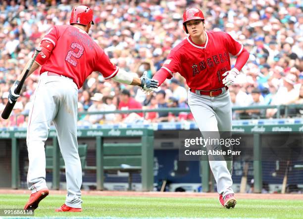 Shohei Ohtani of the Los Angeles Angels of Anaheim celebrates with Andrelton Simmons after scoring on an RBI single by Kole Calhoun in the fourth...