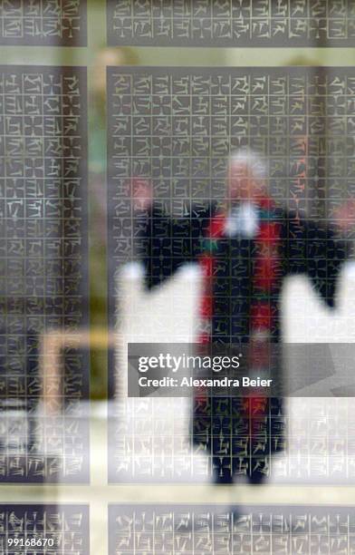 Female priest prays seen through the window of the Herz Jesu church during a holy ecumenical mass at the second day of the 2nd ecumenical Kirchentag...