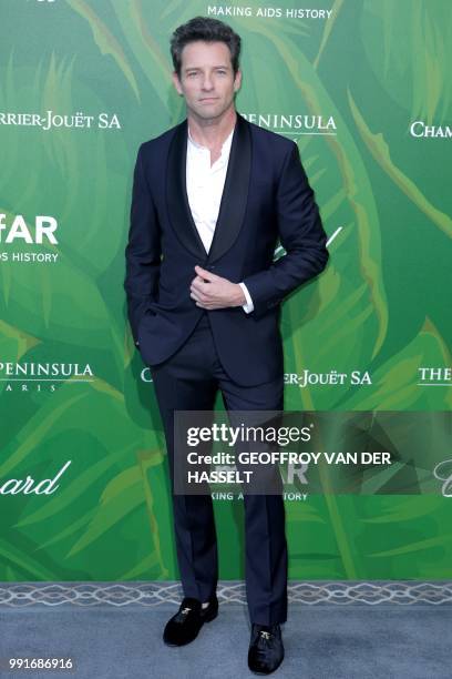 Actor Ian Bohen poses during a photocall as he arrives for a dinner organized by the foundation for Aids research amfAR at The Peninsula in Paris on...