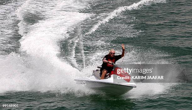 Virgin Group founder Richard Branson arrives on a jet-ski to hold a press conference at the Museum of Islamic Art in Doha on May 13, 2010. Branson...