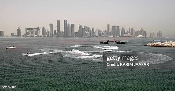 General view shows Virgin Group founder Richard Branson arriving on a jet-ski to the Museum of Islamic Art in Doha to hold a press conference on May...