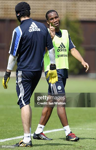 Didier Drogba of Chelsea speaks with team mate Petr Cech during a training session at the Cobham training ground on May 13, 2010 in Cobham, England.