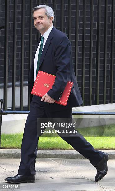 Energy and Climate Change Secretary Chris Huhne leaves Downing Street following the first cabinet meeting of the new coalition government at Downing...