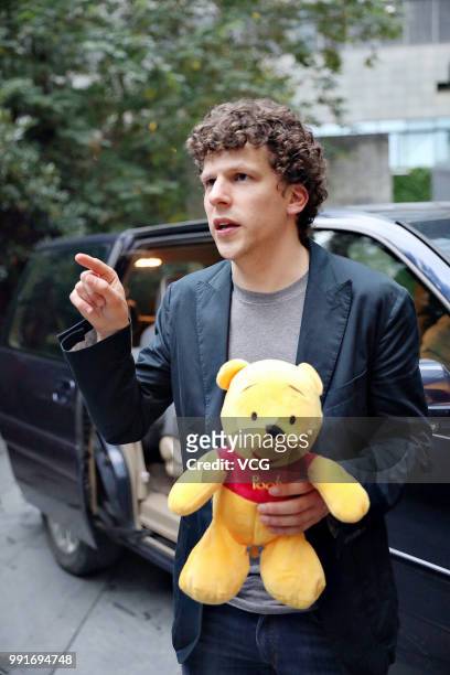 American actor Jesse Eisenberg holding a Pooh Bear toy given by fans is seen on June 30, 2018 in Shanghai, China.