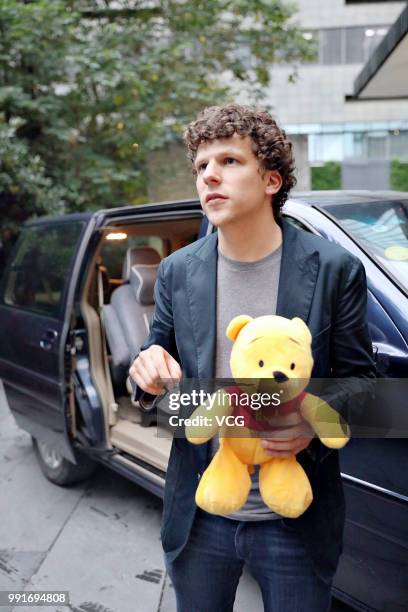 American actor Jesse Eisenberg holding a Pooh Bear toy given by fans is seen on June 30, 2018 in Shanghai, China.