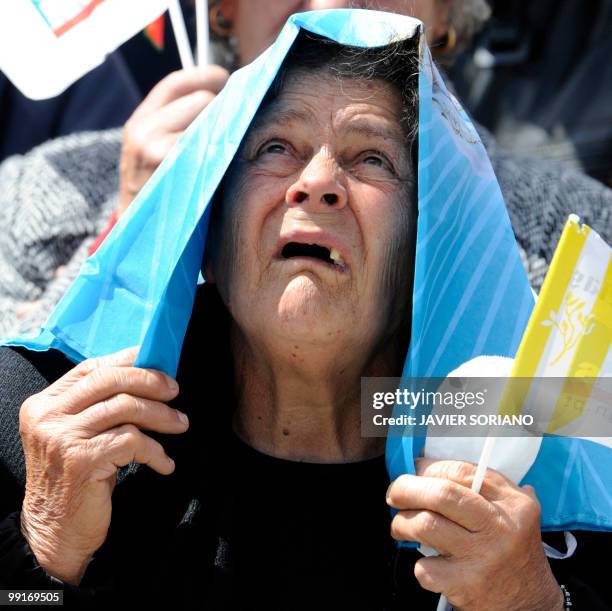 Pilgrim prays during a mass led by Pope Benedict XVI at Fatima's Sanctuary on May 13, 2010. Pope Benedict XVI began a giant outdoor mass in the...