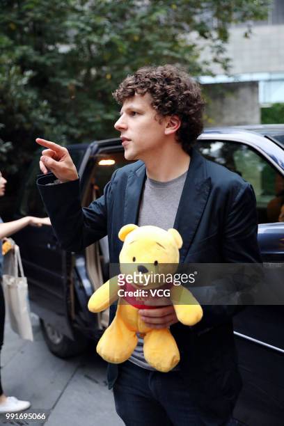 American actor Jesse Eisenberg holding a Pooh Bear toy given by fans is seen on June 30, 2018 in Shanghai, China.