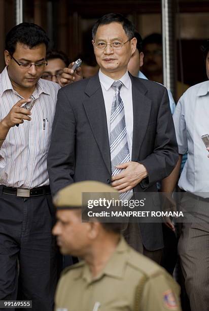 Chinese Ambassador to India Zhang Yan walks with officials and media representatives after a meeting with Indian Home Minister P Chidambaram at his...
