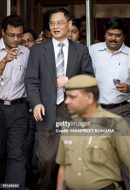 Chinese Ambassador to India Zhang Yan walks with officials and media representatives after a meeting with Indian Home Minister P Chidambaram at his...