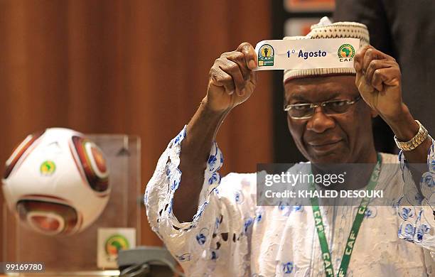 An official holds the name of Angolan club Primeiro Agosto during the African Confederation Cup play-offs and group draws in Cairo on May 13, 2010....