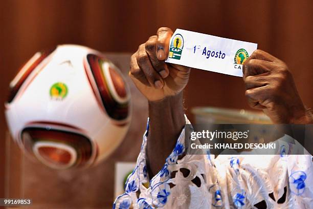 An official holds the name of Angolan club Primeiro Agosto during the African Confederation Cup play-offs and group draws in Cairo on May 13, 2010....