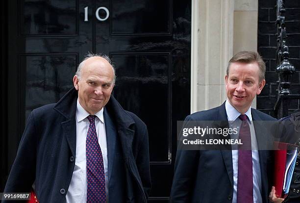 British Liberal Democrat Business Secretary Vince Cable and Conservative Education Secretary Michael Gove leave 10 Downing Street in London, on May...