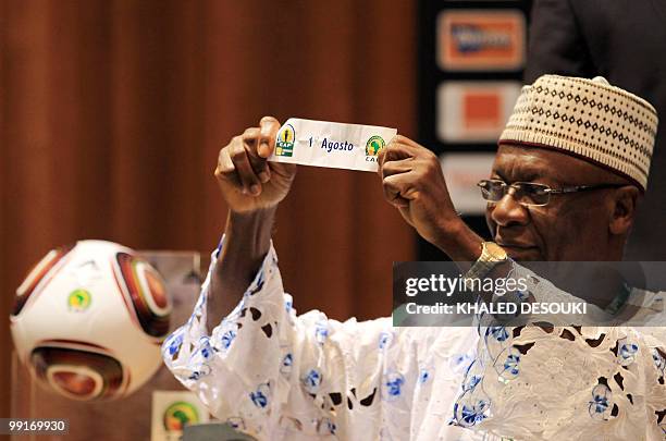 An official holds the name of Angolan club Primeiro Agosto during the African Confederation Cup play-offs and group draws in Cairo on May 13, 2010....