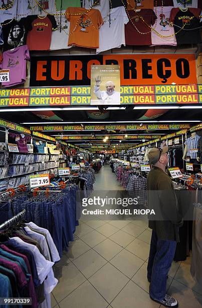 Poster of the Pope Benedict XVI is displayed in a shop on the Aliados Avenue in Porto, on May 13 prior to his official visit to the city. AFP PHOTO /...