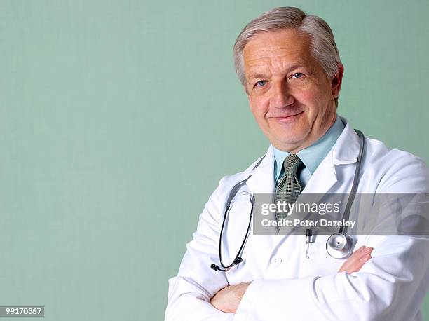 portrait of senior doctor consultant - peter dazeley stock pictures, royalty-free photos & images