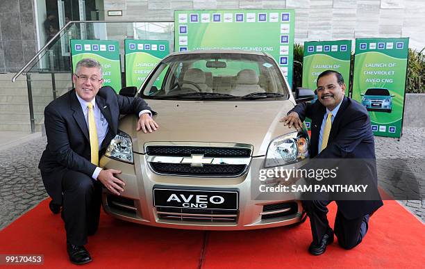 General Motors India President and Managing Director Karl Slym and GMI Director & Vice President P. Balendran pose with a Compressed Natural Gas...