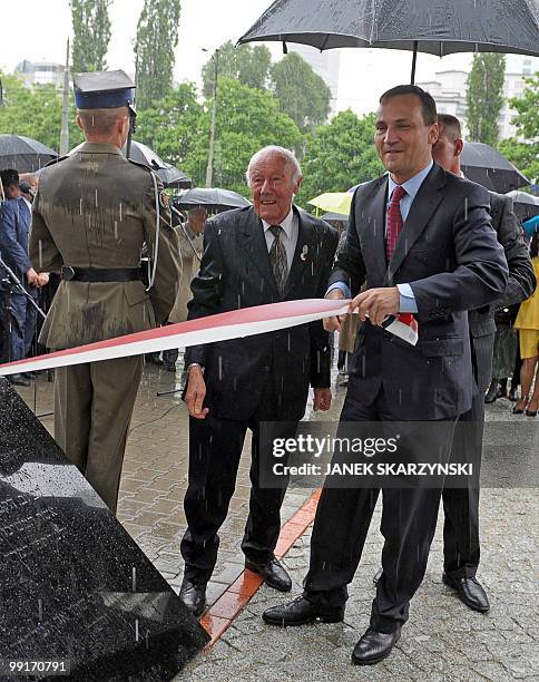 Polish Foreign Minister Radoslaw Sikorski with Simcha Rotem-Ratayzer, a former insurgent in the Warsaw Ghetto Uprising unveil a new monument, in...