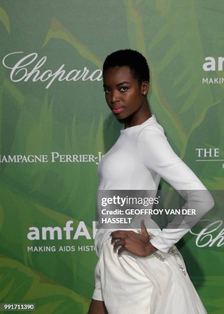 Angolan model Maria Borges poses during a photocall as she arrives for a dinner organized by the foundation for Aids research amfAR at The Peninsula...