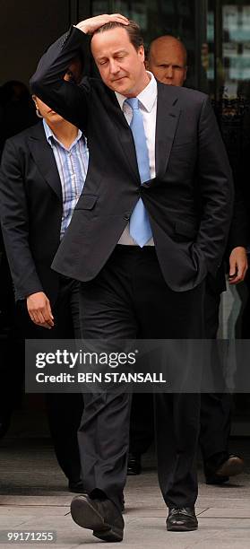 Britain's new Conservative Prime Minister, David Cameron, reacts as he leaves the Home office in central London on May 13, 2010. New British Prime...