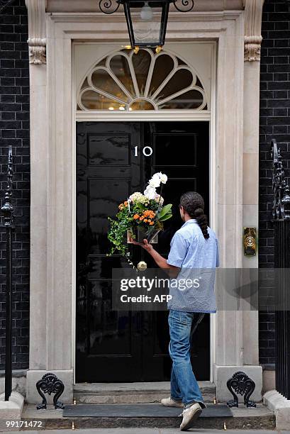 Flowers are delivered to 10 Downing Street, the official residence of Britain's new Conservative Prime Minister, David Cameron, in central London on...