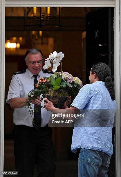 Flowers are delivered to 10 Downing Street, the official residence of Britain's new Conservative Prime Minister, David Cameron, in central London on...